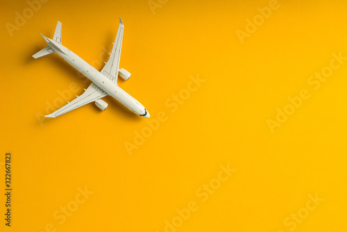 Aircraft top view, Airplane on yellow background with copy space for text, template or mockup. Summer travel theme