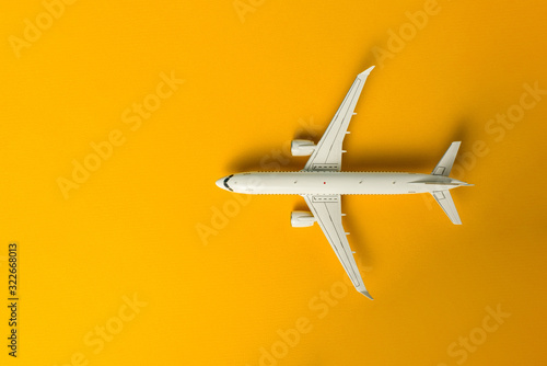 Aircraft top view, Airplane on yellow background with copy space for text, template or mockup. Summer travel theme