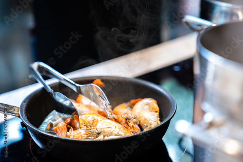 fried and boild big shrimp on the pan in kitchen.