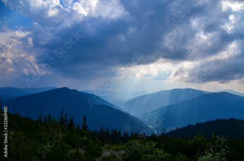 Beautiful blue Carpathian mountains against the background of large cumulus clouds, natural travel background
