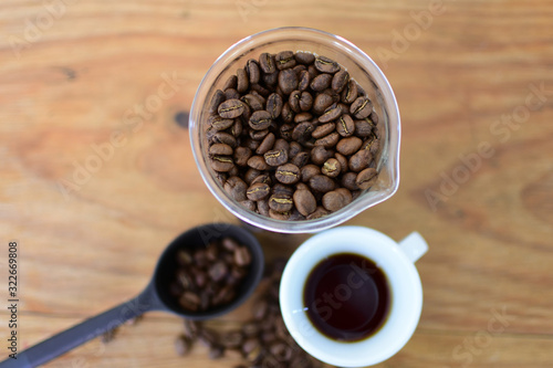 coffee beans, accompanied by cup of hot coffee