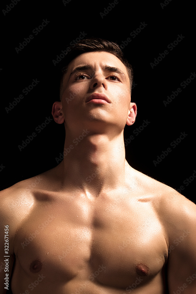 Handsome wet sport sexy stripped guy portrait with waterdrops and smoke on isolated black background Handsome wet sport sexy stripped guy portrait with waterdrops and smoke on isolated black background