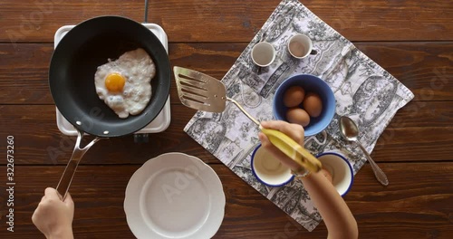 Top view food. Cooking With Mother. Beautiful Little Girl Learns How To Make Fried Egg.