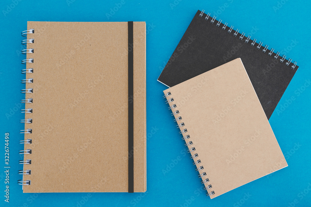group of minimalist looking notebooks of different shapes on blue group of minimalist looking notebooks of different shapes on blue