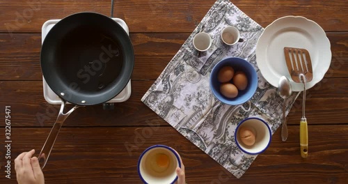 Top view food. Cooking With Mother. Beautiful Little Girl Learns How To Make Fried Egg.