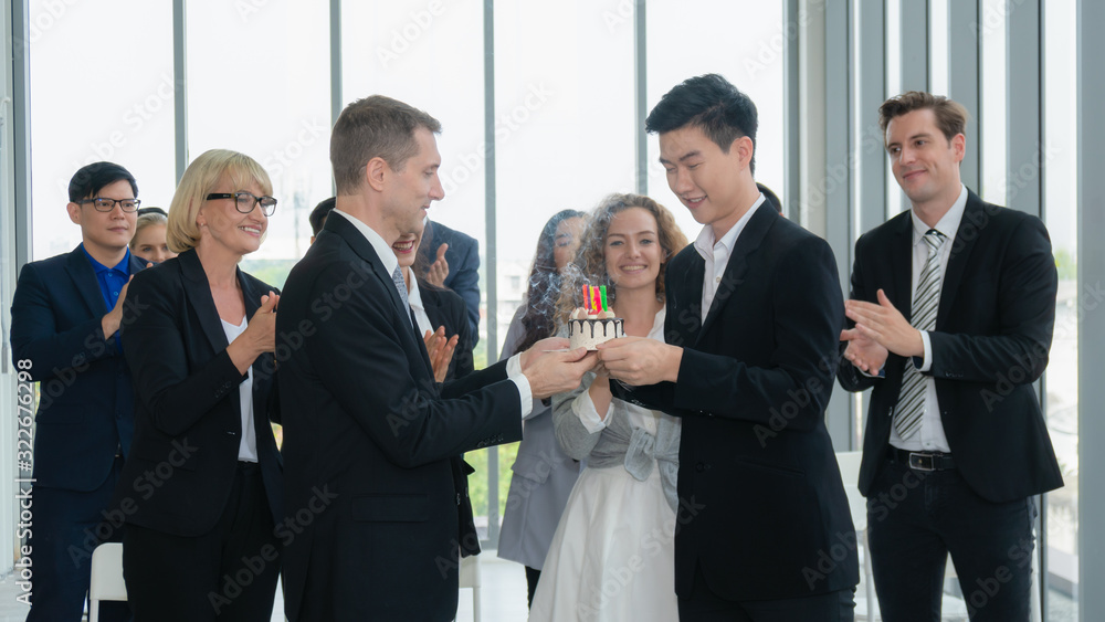 business background of birthday celebration of young male business executive in office with many colleagues happy together business background of birthday celebration of young male business executive in office with many colleagues happy together