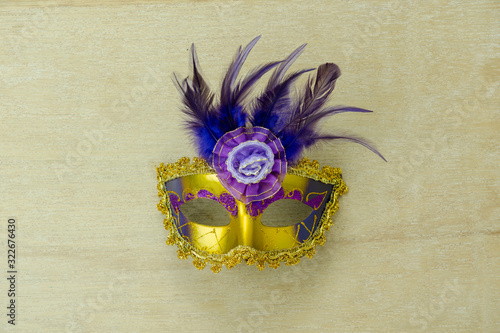 Fototapeta Naklejka Na Ścianę i Meble -  Table top view aerial image of beautiful colorful carnival festival background.Flat lay accessory object the fancy mask for the season on modern red paper at home office desk studio.copy space.