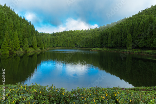 Lake called "Lagoa das Empadadas" in portuguese, surrounded by green pine forest located on Sao Miguel, Azores, Portugal. © cicerocastro