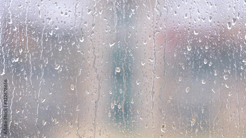 Rain drops on window glasses surface with blur building background, 4k movie, b roll shot, fast motion time lapse. Rain drops on window glasses surface with blur building background, 4k movie, b roll shot, fast motion time lapse.