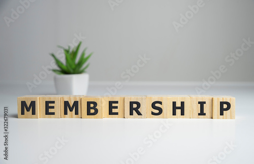 focus on wooden blocks with letters making Membership text. Concept image. photo