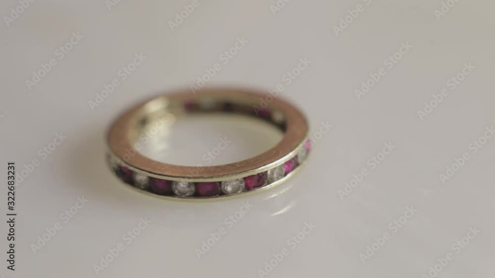 Beautiful Gold Wedding Ring Embellished With White And Purple Diamonds - Closeup Shot Beautiful Gold Wedding Ring Embellished With White And Purple Diamonds - Closeup Shot