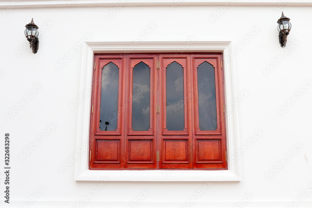 Fototapeta premium Red brown wood window and white wall, retro style window is closed. 