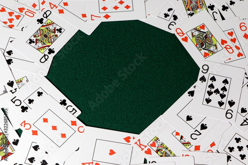 Playing cards for poker on a green table. Gambling.