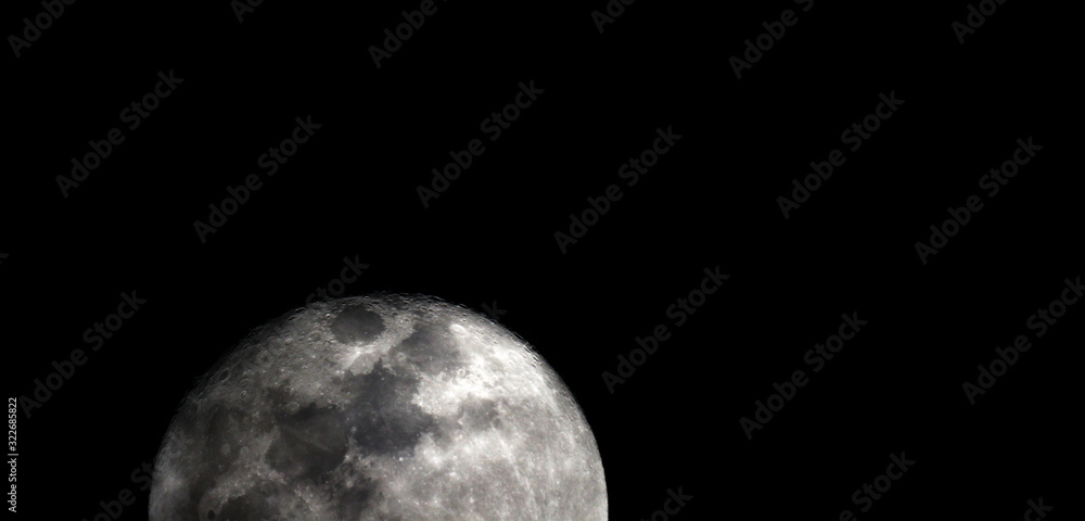 Naklejka premium Full moon texture / It is the fifth-largest satellite in the Solar System, and by far the largest among planetary satellites relative to the size of the planet that it orbits.