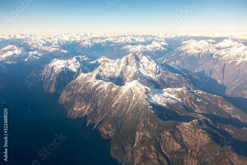 Canvas Print Aerial Landscape View flying over Coast Mountains of British Columbia, Canada from plane window