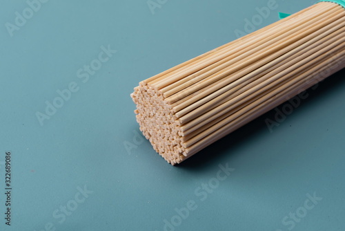 Bamboo sticks made of bamboo are often used as barbecue tools on a green background