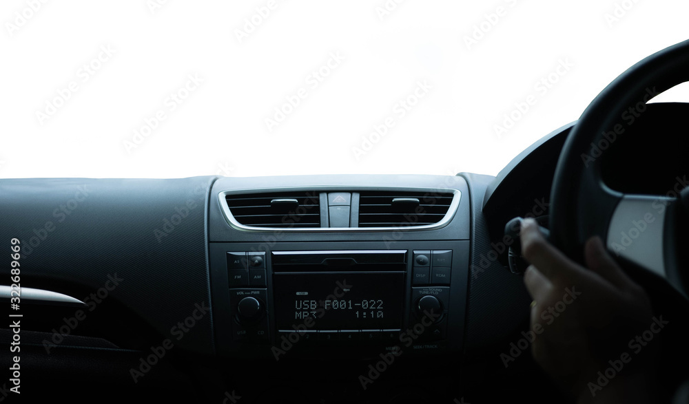 Driver's hand on the black steering wheel with dashboard inside of a car isolated on white background.