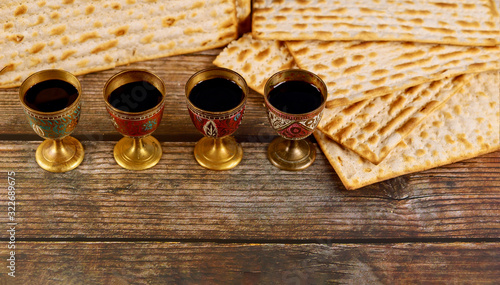 Four cups full of wine with matzah. Jewish holidays Passover.