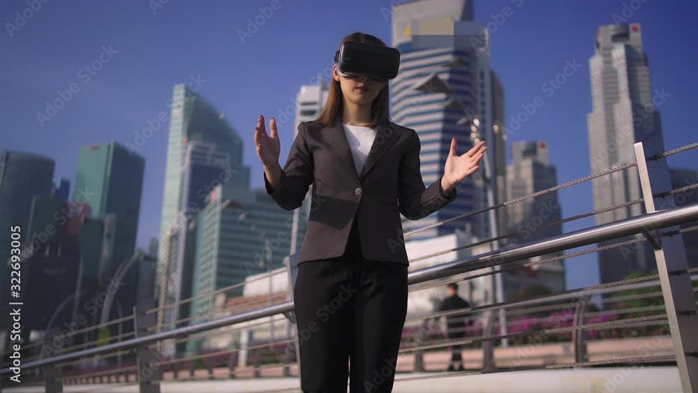 Future is now. Woman using virtual reality device while traveling in Singapore . Future is now. Woman using virtual reality device while traveling in Singapore .