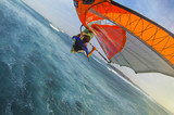 Selfie photo of flying windsurfer over stormy waters