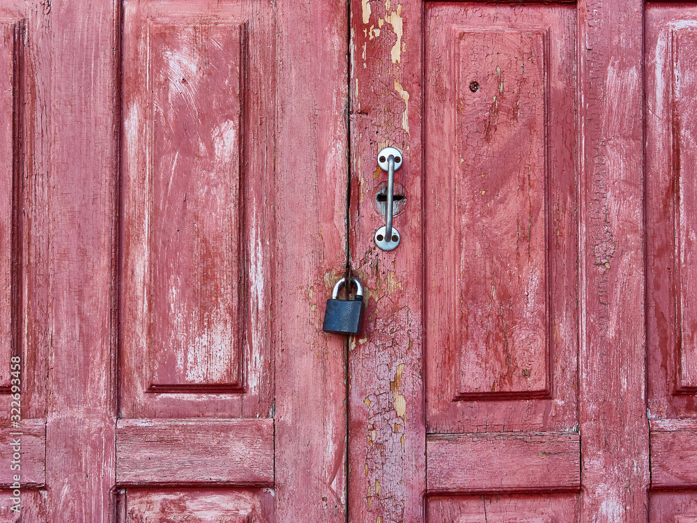 Old weathered barn doorwith with padlock Old weathered barn doorwith with padlock
