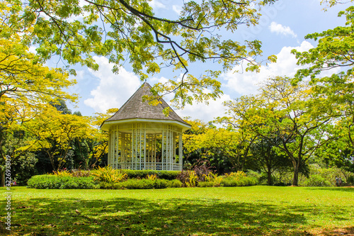 Wooden house gazebo in the colorful tropical garden