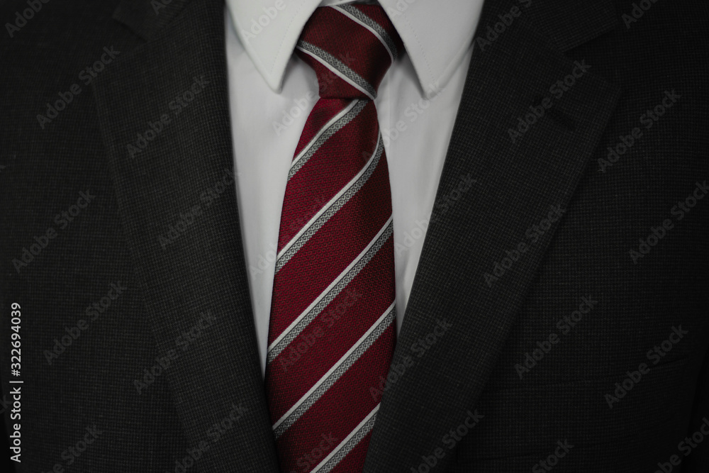 Man in grey suit with red and white tie Man in grey suit with red and white tie