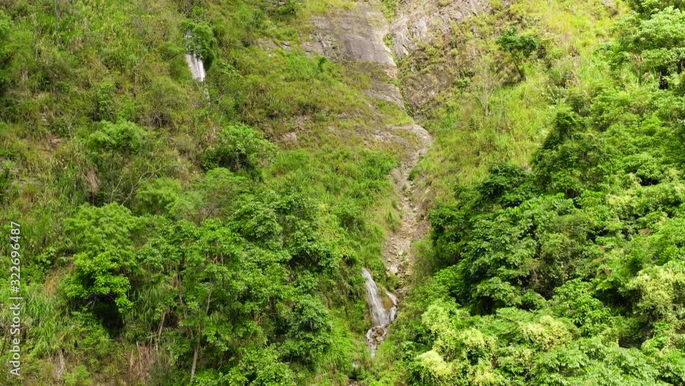 Cliff with a waterfall in the jungle. Cascade Waterfall on Luzon Island, Philippines. Cliff with a waterfall in the jungle. Cascade Waterfall on Luzon Island, Philippines.