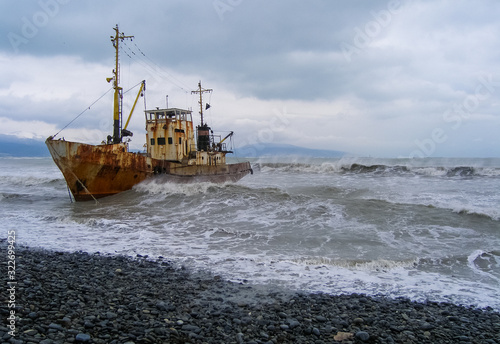 Abandoned fishing boat beached by the strong storm