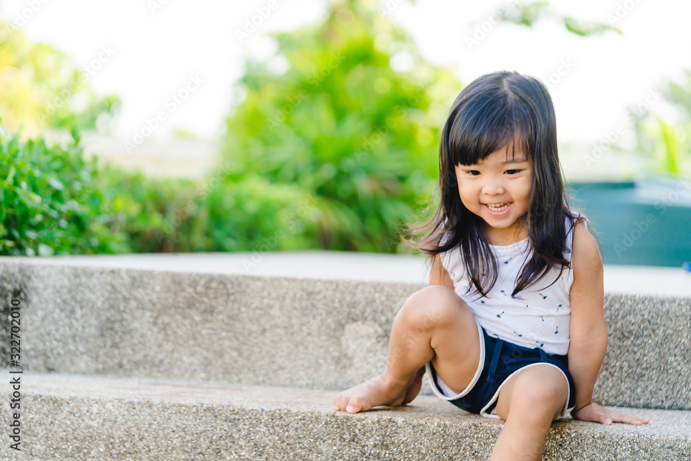 Toddler asian girl climbing and walking down the stairs at home.Concept of happy childhood and Child development. Toddler asian girl climbing and walking down the stairs at home.Concept of happy childhood and Child development.