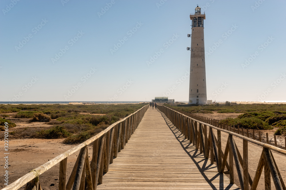 wooden jetty to the ocean and lighthouse, Morro Jable Beach - Fuerteventura