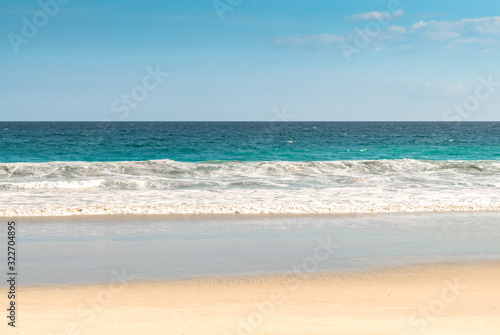 Scenic View of Secluded Beach from a tropical island, with calm sea waves, clear Blue sky and visible horizon. A Dream destination for holidays/vacation and spending some time in leisure with nature.