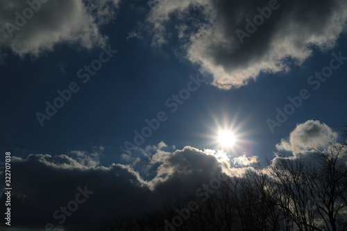 sun in the autumn sky is covered with clouds. Abstract background.