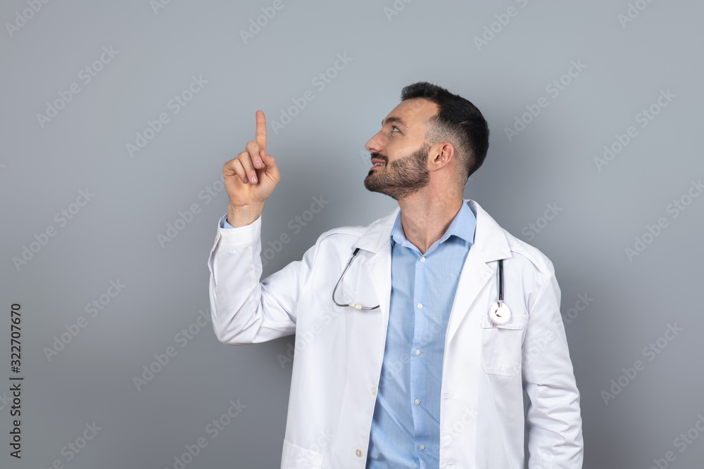 Doctor in white robe pointing to something Doctor in white robe pointing to something