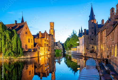 Bruges city skyline with canal at night in Belgium photo