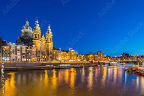 Amsterdam city skyline with landmark building at night in Netherlands