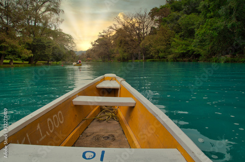 yellow boat point of view (EL SALTO-EL MECO) san luis potosi México, hermosa cascada Turquoise water in a river and cliffs of the reserve. Beautiful natural canyon, blue river water and boating photo