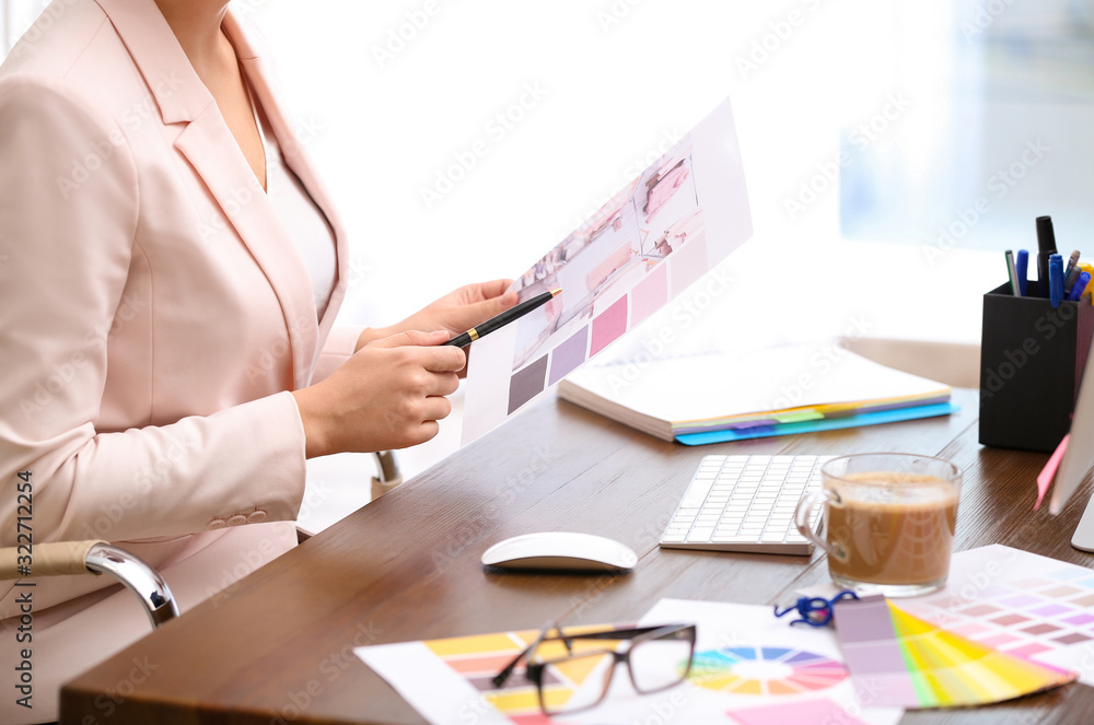 Female designer working at desk in office, closeup Female designer working at desk in office, closeup