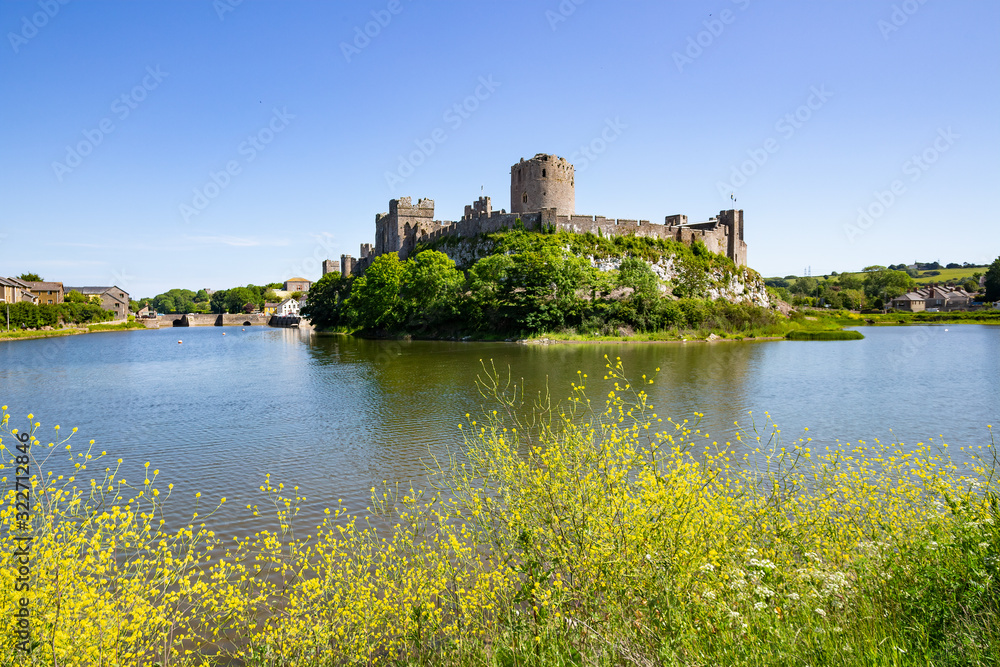 A summer's day view of Pembroke Castle, which is a medieval castle in Pembroke, Pembrokeshire, Wales.