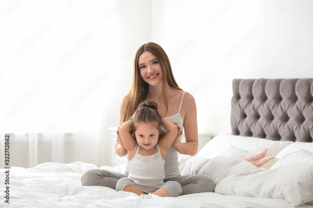 Happy mother with little daughter in bedroom Happy mother with little daughter in bedroom