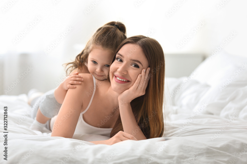 Happy mother with little daughter in bedroom Happy mother with little daughter in bedroom