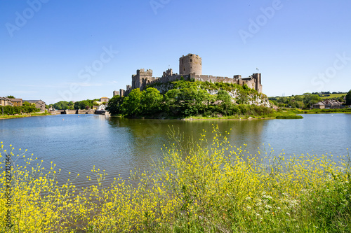 A summer's day view of Pembroke Castle, which is a medieval castle in Pembroke, Pembrokeshire, Wales.