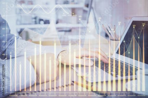 Multi exposure of stock market chart with man working on computer on background. Concept of financial analysis. © peshkova