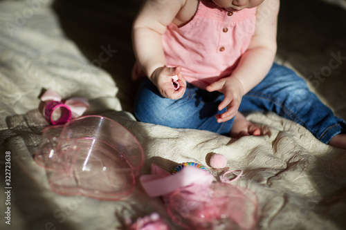 baby plaing with different hairpins photo