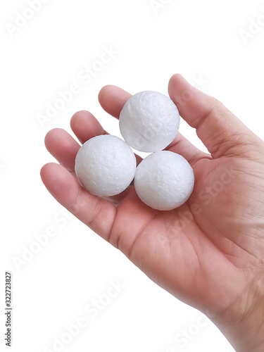 Man's hand holding three white blank styrofoam ball against the white background