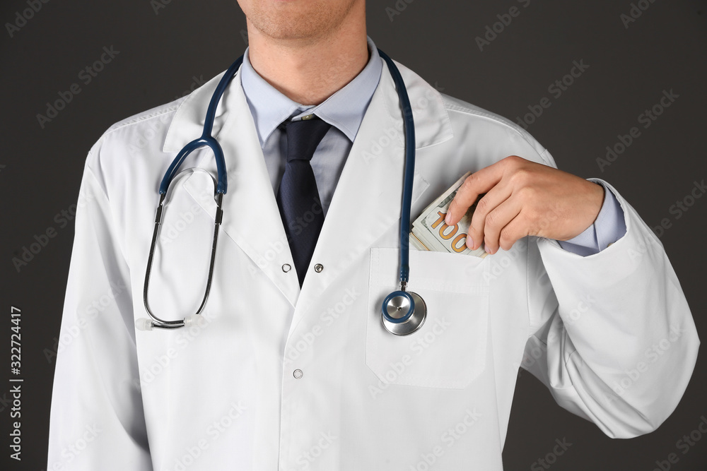 Doctor putting bribe into pocket on black background, closeup. Corruption in medicine Doctor putting bribe into pocket on black background, closeup. Corruption in medicine