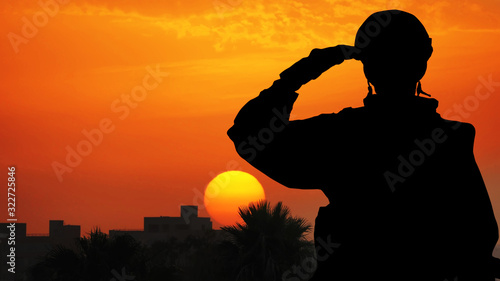 Silhouette Of A Solider Saluting Against the Sunrise in a town on the Mediterranean coast. Concept - armed forces of Turkey, Israel, Egypt