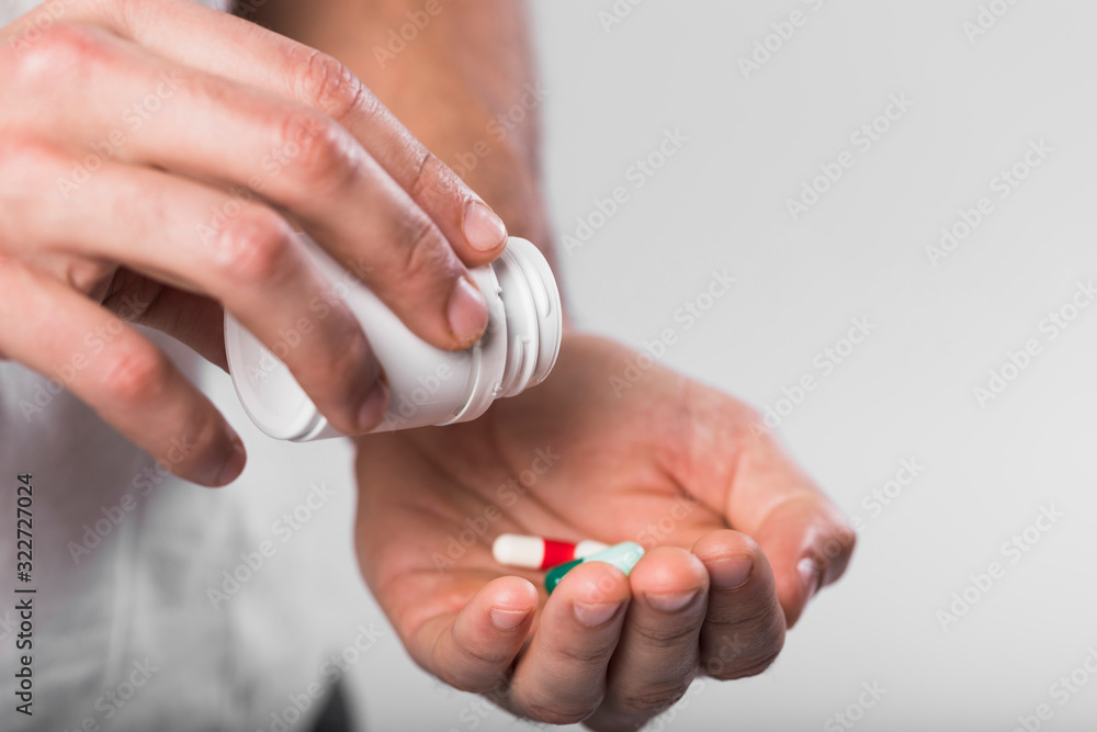 Close-up hands holding medical capsules Close-up hands holding medical capsules