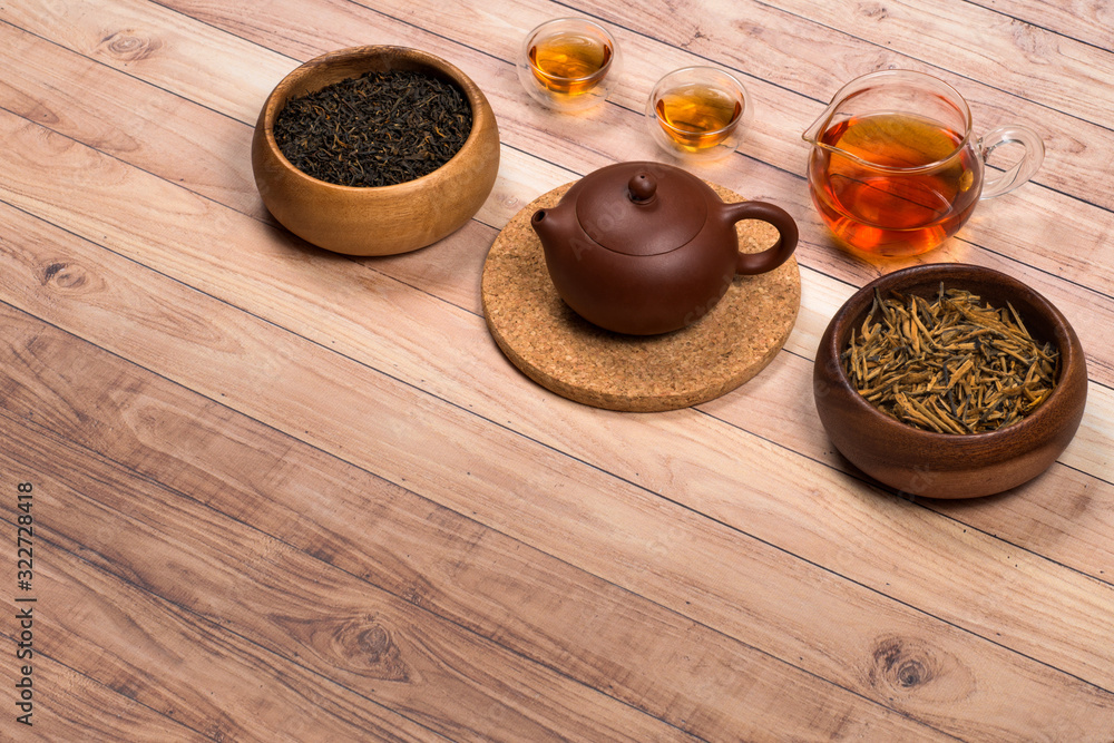 Chinese tea set and accessories on an old wooden table Chinese tea set and accessories on an old wooden table