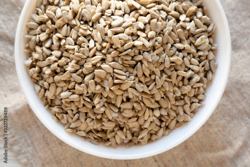 Raw Sunflower Seed Kernels in a white bowl, view from above. Flat lay, top view, overhead. Raw Sunflower Seed Kernels in a white bowl, view from above. Flat lay, top view, overhead.